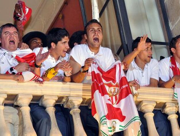 Los jugadores del Sevilla saludan a los aficionados desde el Ayuntamiento.

Foto: Manuel G&oacute;mez