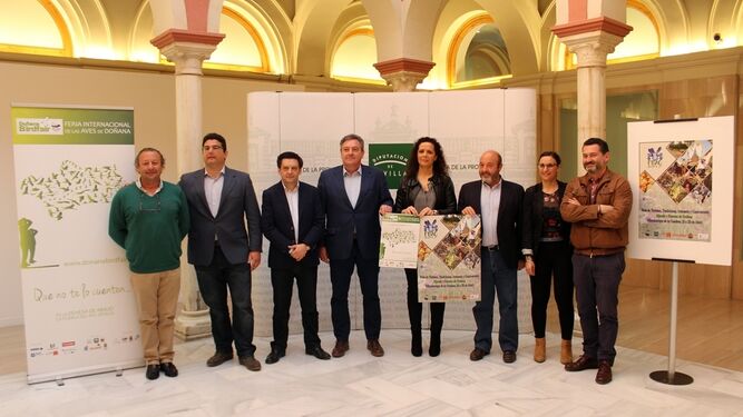 Sosteniendo los carteles de las dos ferias, la diputada Rocío Sutil y los alcaldes de La Puebla del Río y Villamanrique.