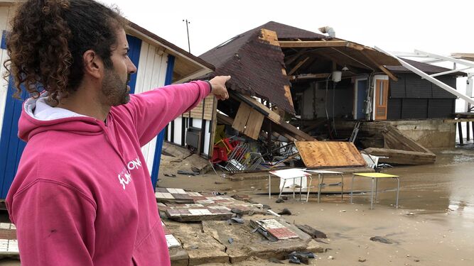 El propietario de un chiringuito de La Antilla señala los destrozos en su establecimiento.