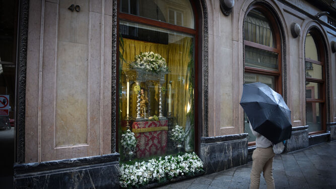 Una persona contempla, bajo el paraguas, un escaparate de la calle Francos.