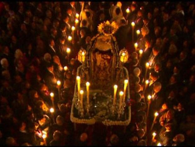 La Virgen del Mayor y Traspaso iluminada por las velas portadas en el cortejo.