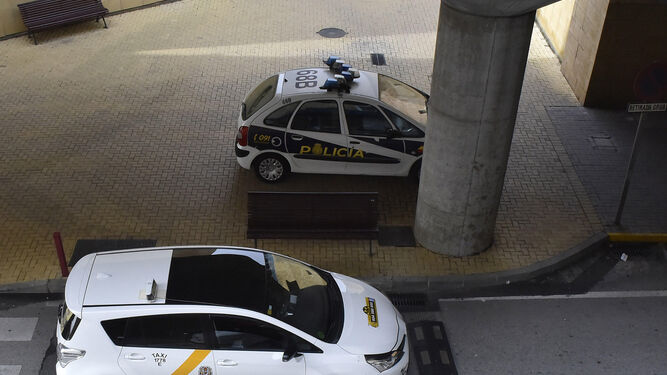 Un patrullero de la Policía Nacional junto a dos taxis en el aeropuerto.