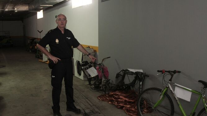El inspector José María Belloso muestra dos chasis de motos recuperadas, en el garaje de la comisaría de Sevilla Este.