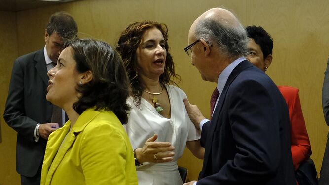 María Jesús Montero conversa con el ministro Cristóbal Montoro. En primer término, Soraya Sáenz de Santamaría.