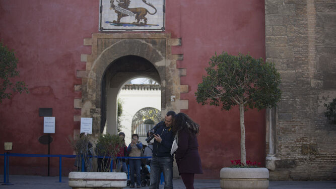 Dos turistas ante la Puerta del León del Real Alcázar, entrada principal al monumento.