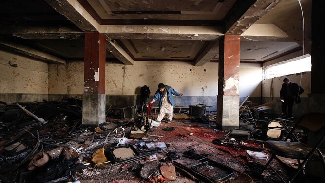 Un afgano comprueba los destrozos en el escenario del ataque suicida perpetrado ayer contra una madrasa en Kabul.