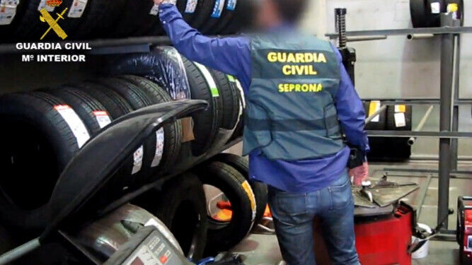Una gente inspecciona los neumáticos de la empresa investigada.