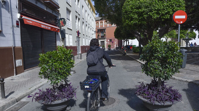 Una mujer en bicicleta cruza por el tramo de la plaza de San Leandro que ha sido peatonalizado.