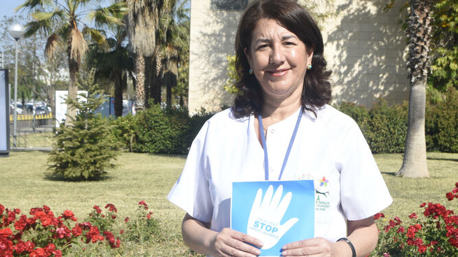 María Jesús Romero, con un folleto sobre la higiene de manos.