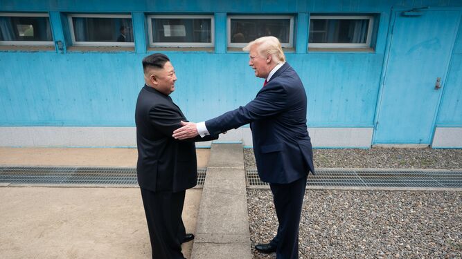 Kim Jong-un y Donald Trump se saludan en la zona desmilitarizada.
