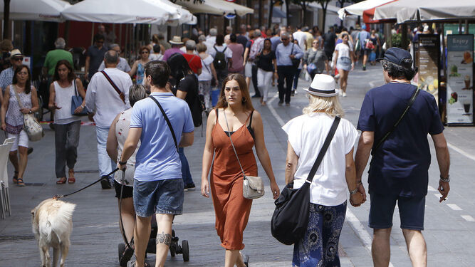 Una calle de Sevilla repleta de viandantes.