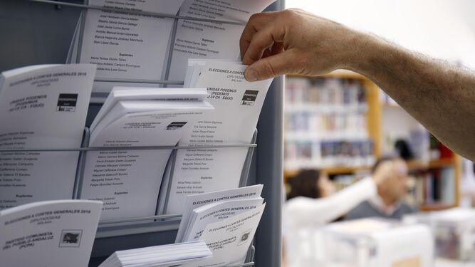Un ciudadano elige una papeleta en un colegio electoral.