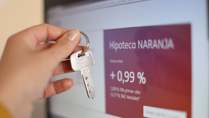 Un usuario, llave en mano, consulta las condiciones hipotecarias en una página web.