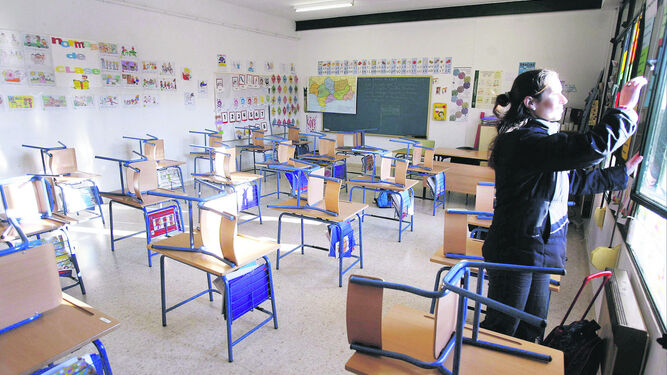 Una maestra en un aula sin alumnos.