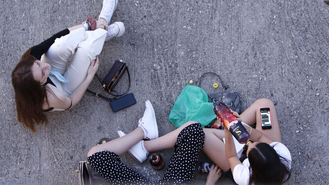 Varias jóvenes bebiendo en la calle.