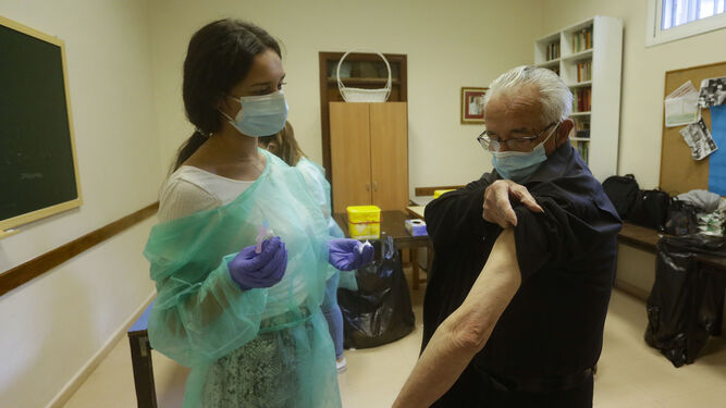Un hombre recibe la vacuna de la gripe.