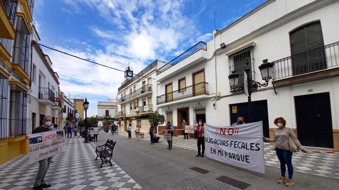Los vecinos concentrados ante el Ayuntamiento de Coria, con pancartas en contra de la Estación de Bombeo de Aguas Residuales en el parque de la calle Tejares.