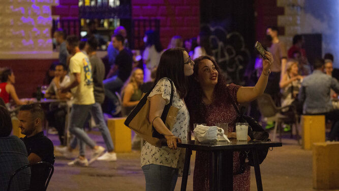 Varias personas disfrutan de la noche del sábado en Sevilla tras el fin del estado de alarma.