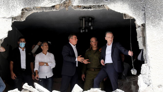 El ministro de Exteriores alemán, Heiko Maas (d), observa una casa bombardeada junto a su homólogo israelí, Gabi Ashkenazi, en la ciudad de Petah Tikva.