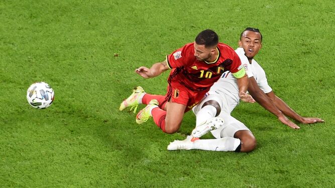 Koundé se tira a ras del césped para cortar un avance de Hazard.