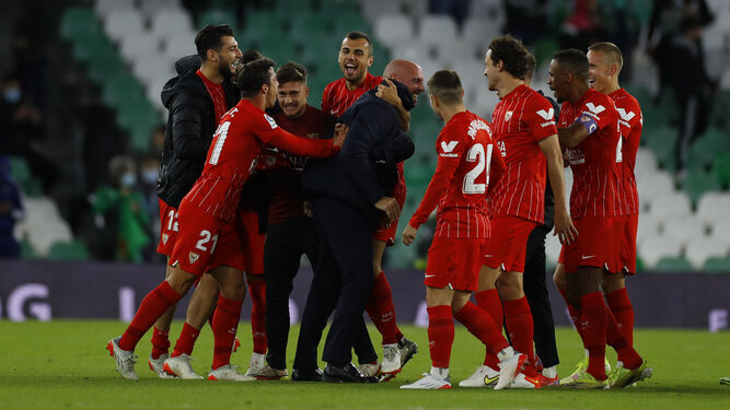 Monchi es abrazado por los jugadores del Sevilla mientras se vacía el Benito Villamarín.