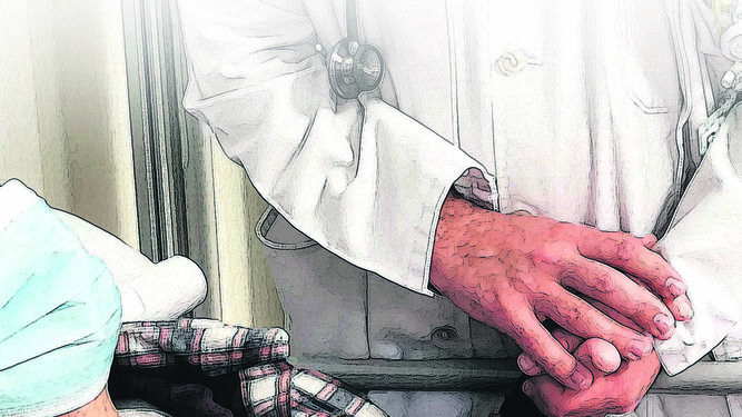 Personal sanitario coge las manos de un enfermo en la camilla de un hospital.