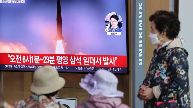 Una mujer observa las noticias en la Estación de Seúl.
