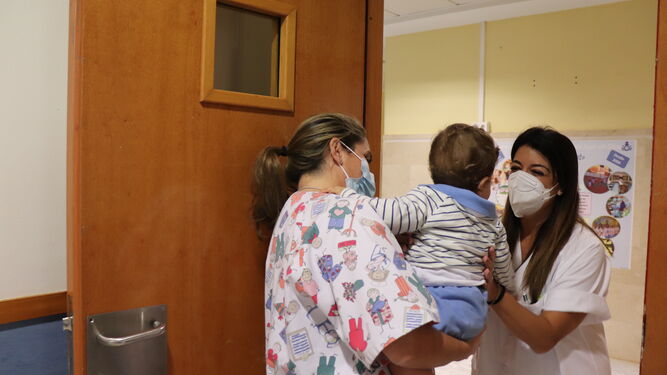 Personal sanitario con un bebé en el centro educativo en las instalaciones del hospital.