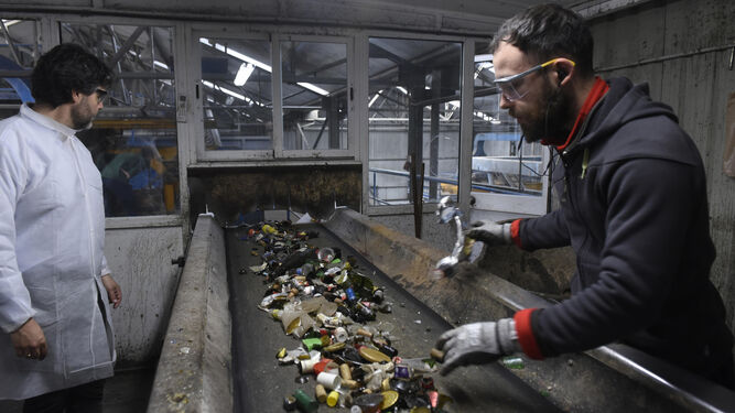 Operarios trabajan en una planta de reciclaje de vidrio en Alcalá de Guadaira (Sevilla).