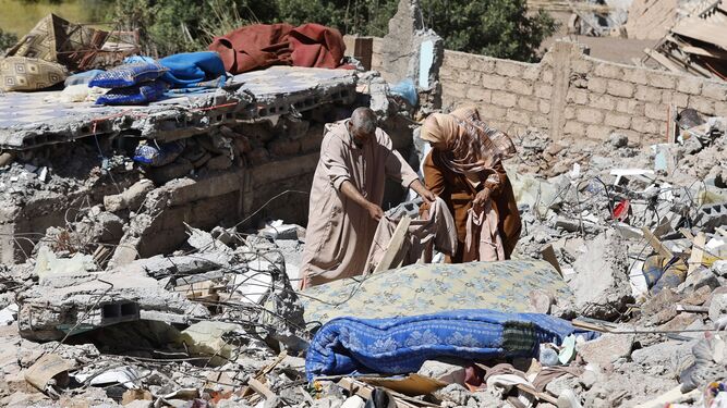Una pareja busca sus pertenencias entre los restos de su vivienda destrozada en Talat N'Yaaqoub, al sur de Marrakech.