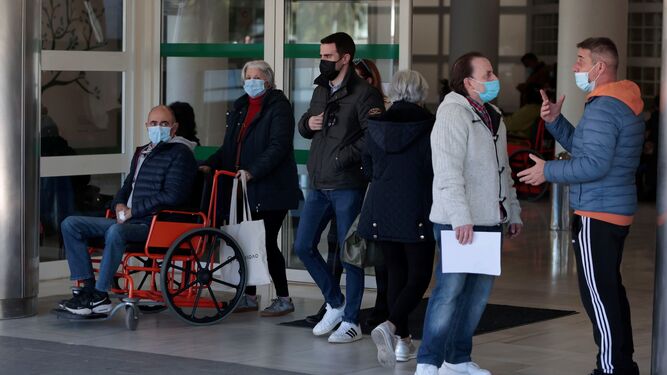 Varias personas, con mascarilla, a las puertas del Hospital General del Virgen del Rocío.