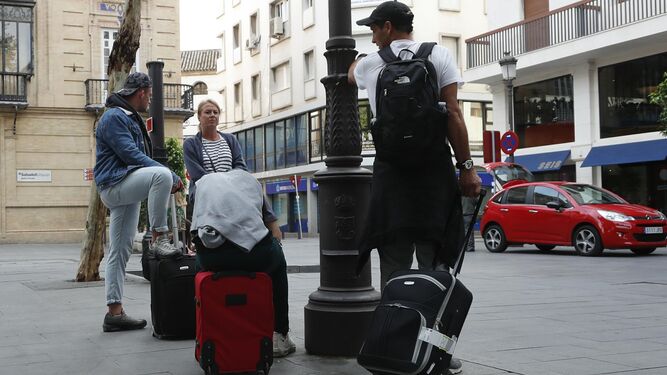 Turistas con maletas en el centro de Sevilla.